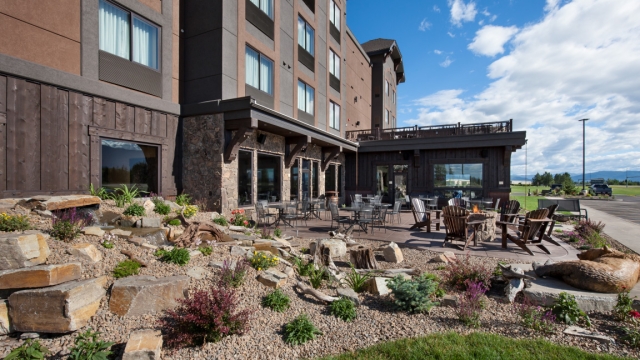 Exterior, horizontal, outdoor patio with fire pit, Country Inns & Suites, Kalispell, Montana; Greg Bain & Company montana builder greg bain landscape patio